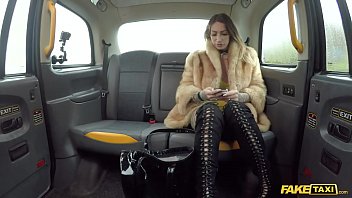 Ava Austen rides a massive black toy in the back of a fake cab